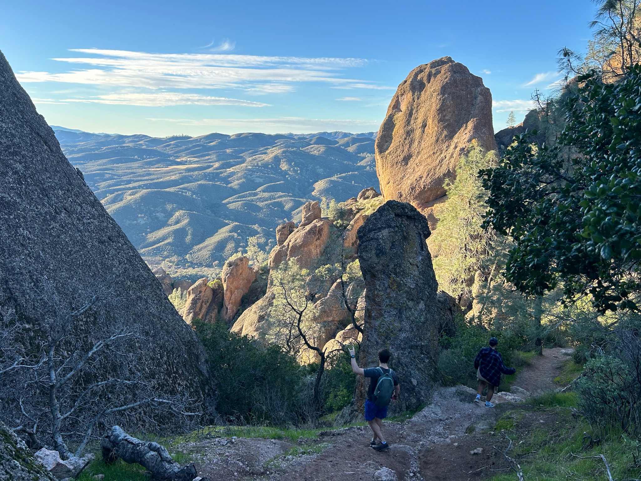 Hikers hiking through rock formation on High Peaks Trail